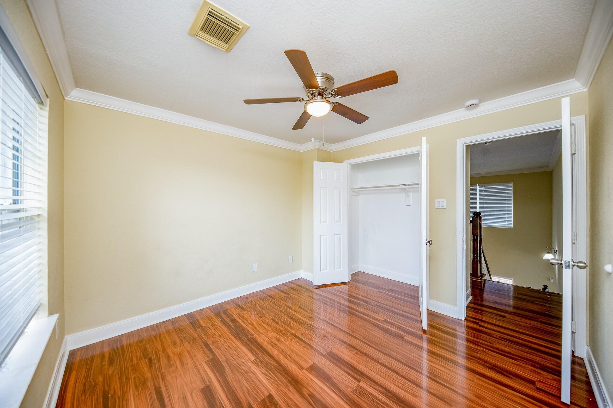 4409 Juan Carlos Court Rosenberg, TX 77471 - Photo 22 of 32 a bedroom with a bed and a ceiling fan