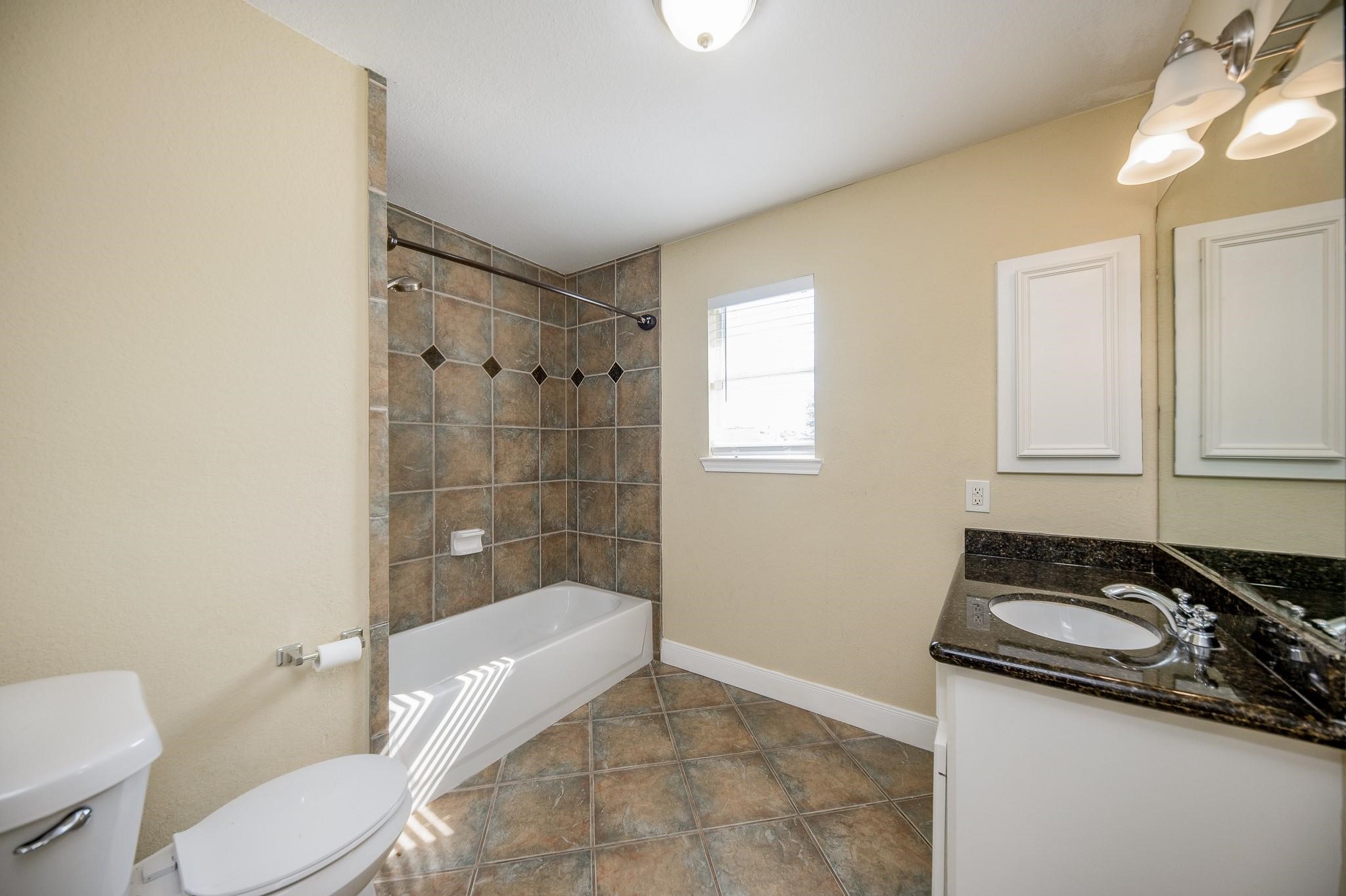 4409 Juan Carlos Court Rosenberg, TX 77471 - Photo 24 of 32 a bathroom with a sink a toilet and shower