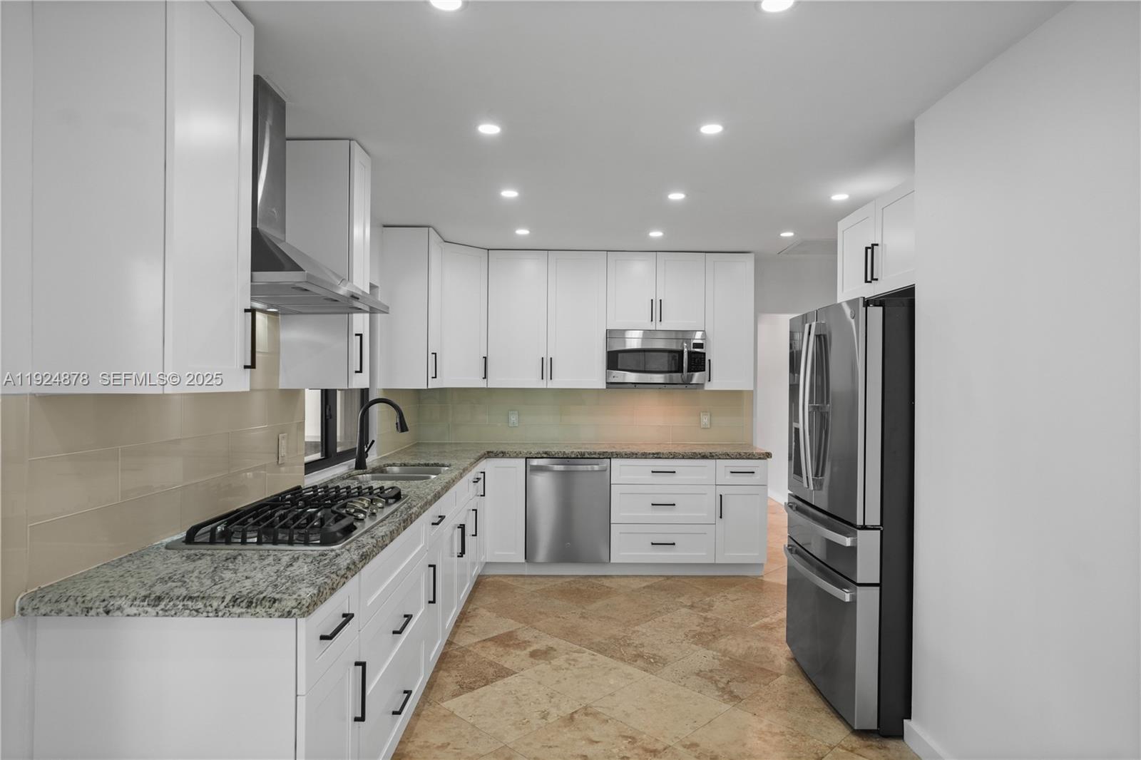 19911 Southwest 82nd Place Cutler Bay, FL 33189 - Photo 11 of 43 a kitchen with stainless steel appliances granite countertop a refrigerator sink and cabinets