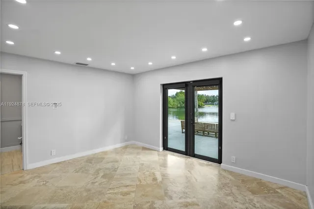 a bedroom with a bed and glass window