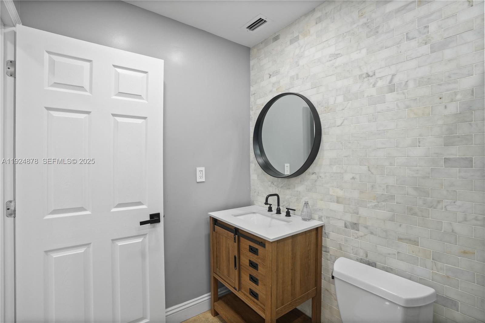 19911 Southwest 82nd Place Cutler Bay, FL 33189 - Photo 24 of 43 a bathroom with a sink and a mirror