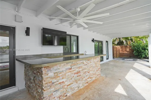 a room with pool table and chairs