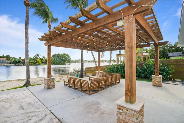 a view of a swimming pool with a couches in a patio