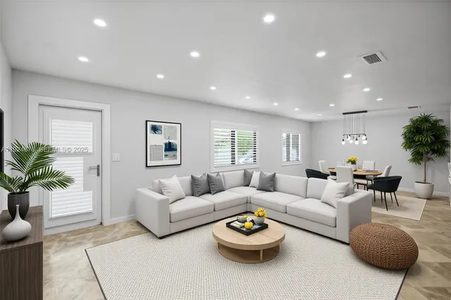 a living room with furniture and a wooden floor