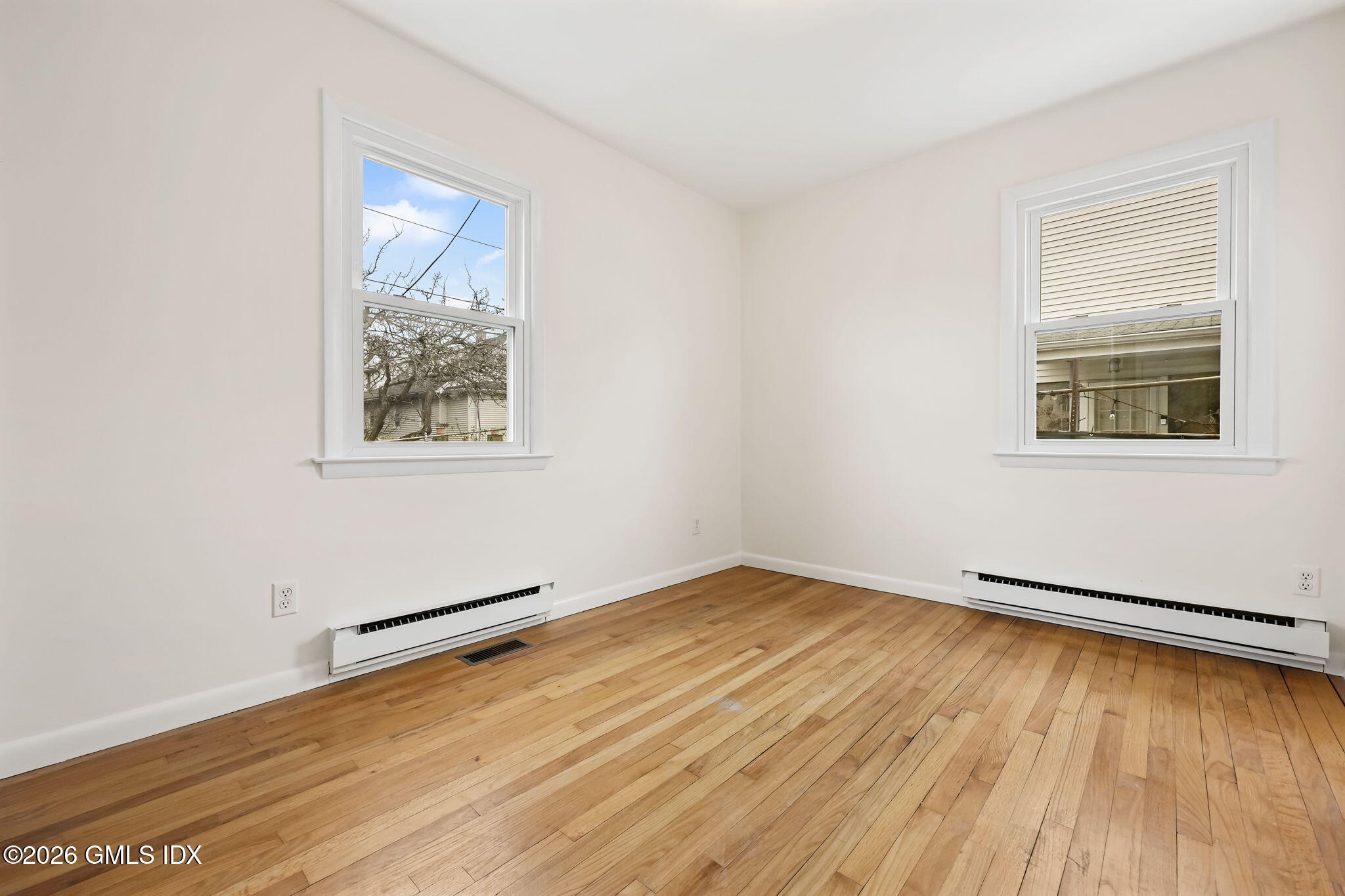 2 Grange Street Greenwich, CT 06830 - Photo 11 of 31 an empty room with wooden floor and windows