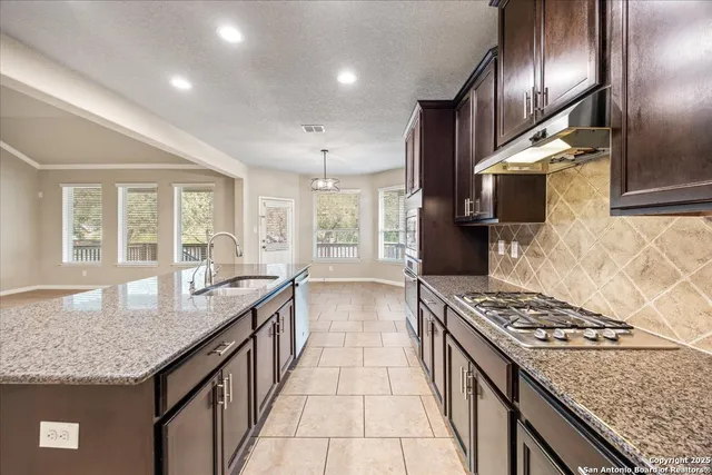 a kitchen with stainless steel appliances granite countertop a stove and a center island