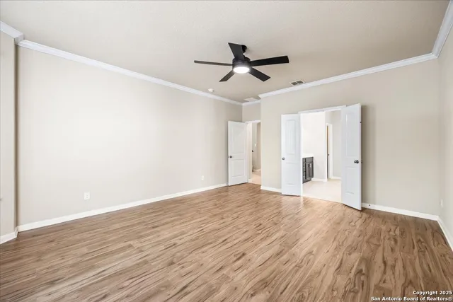 a view of empty room with wooden floor