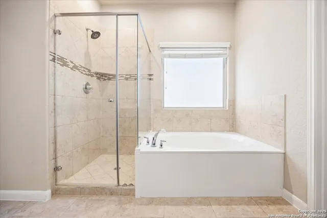 a bathroom with a bathtub and a shower
