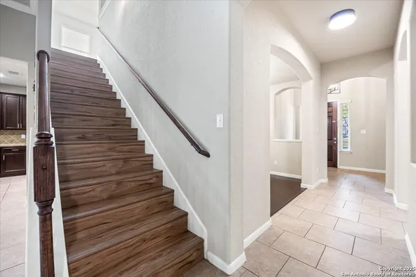 a view of entryway and hall with wooden floor
