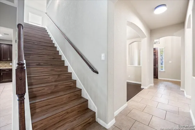a view of entryway and hall with wooden floor