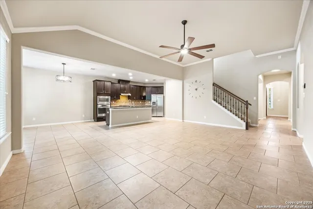 a view of a livingroom with furniture and a ceiling fan