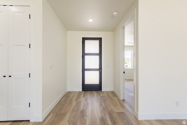 3322 250 S Street Vernal, UT 84078 - Photo 4 of 37 Entryway featuring a modern black door with frosted glass panels, wood-finish flooring, white walls, and recessed lighting