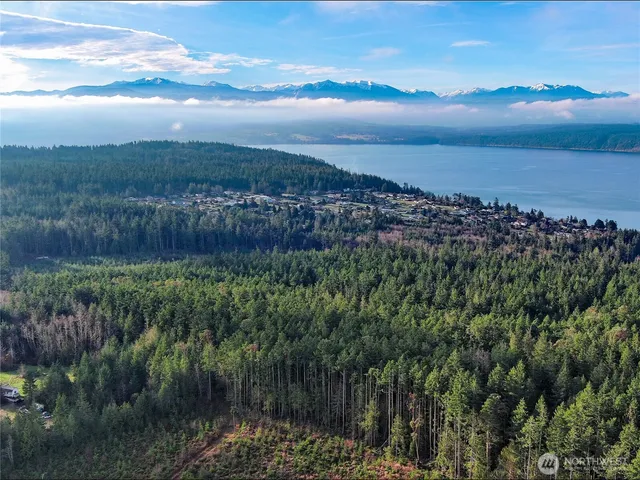 a view of a lake with sunset in background