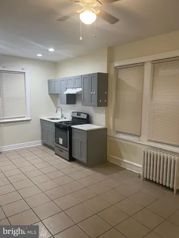 a kitchen with stainless steel appliances a sink stove and cabinets