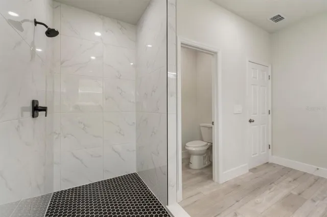 a bathroom with a granite countertop shower toilet and a sink