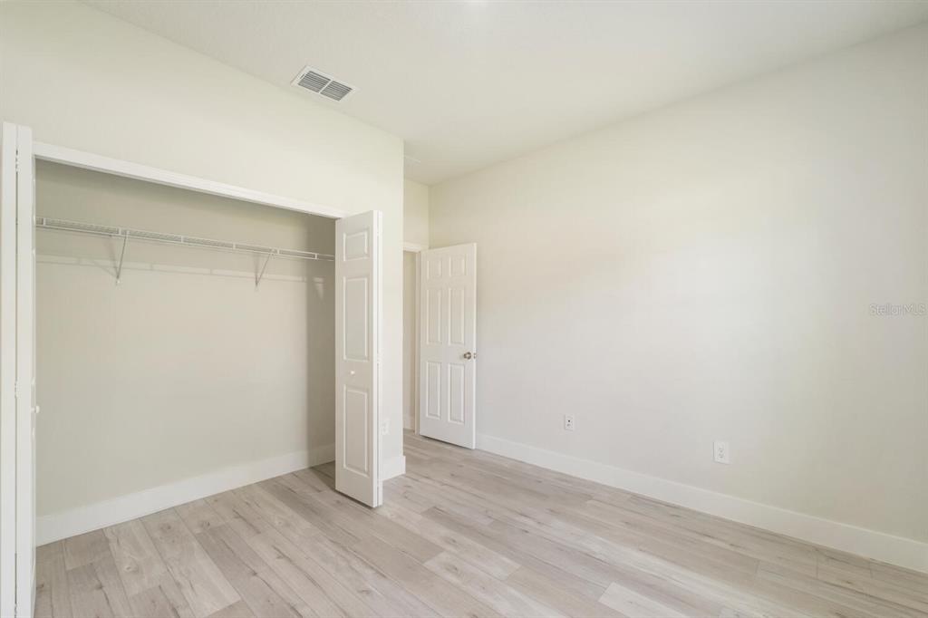 9371 North Cougar Paw Drive Dunnellon, FL 34433 - Photo 28 of 34 an empty room with wooden floor and windows