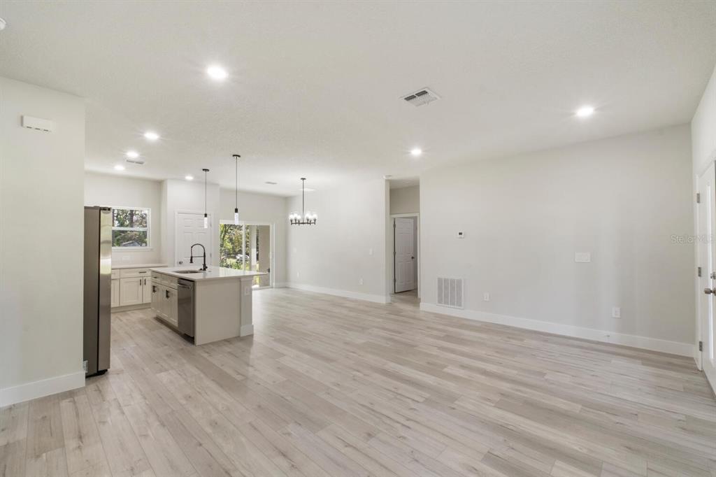 9371 North Cougar Paw Drive Dunnellon, FL 34433 - Photo 7 of 34 a view of kitchen with refrigerator stove and wooden floor
