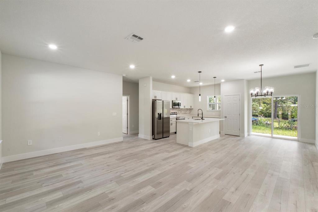 9371 North Cougar Paw Drive Dunnellon, FL 34433 - Photo 9 of 34 a view of a kitchen with kitchen island wooden floor center island and stainless steel appliances