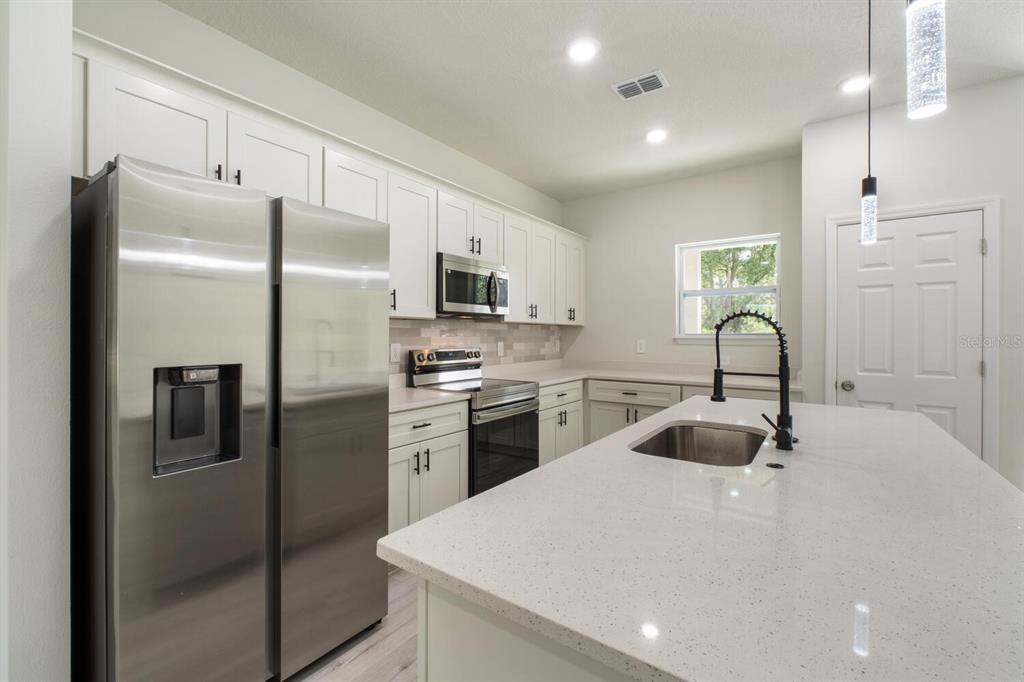 9371 North Cougar Paw Drive Dunnellon, FL 34433 - Photo 10 of 34 a kitchen with refrigerator a sink and cabinets
