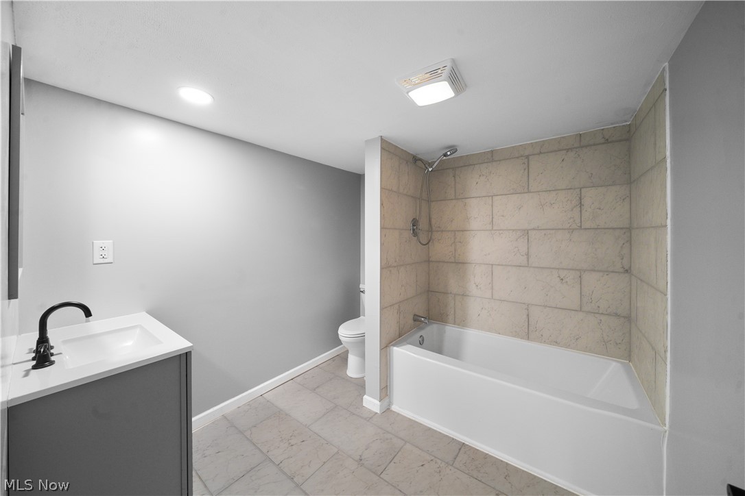 6180 Mackel Road Northeast Minerva, OH 44657 - Photo 4 of 8 Full bathroom featuring tile flooring, toilet, vanity, and tiled shower / bath combo