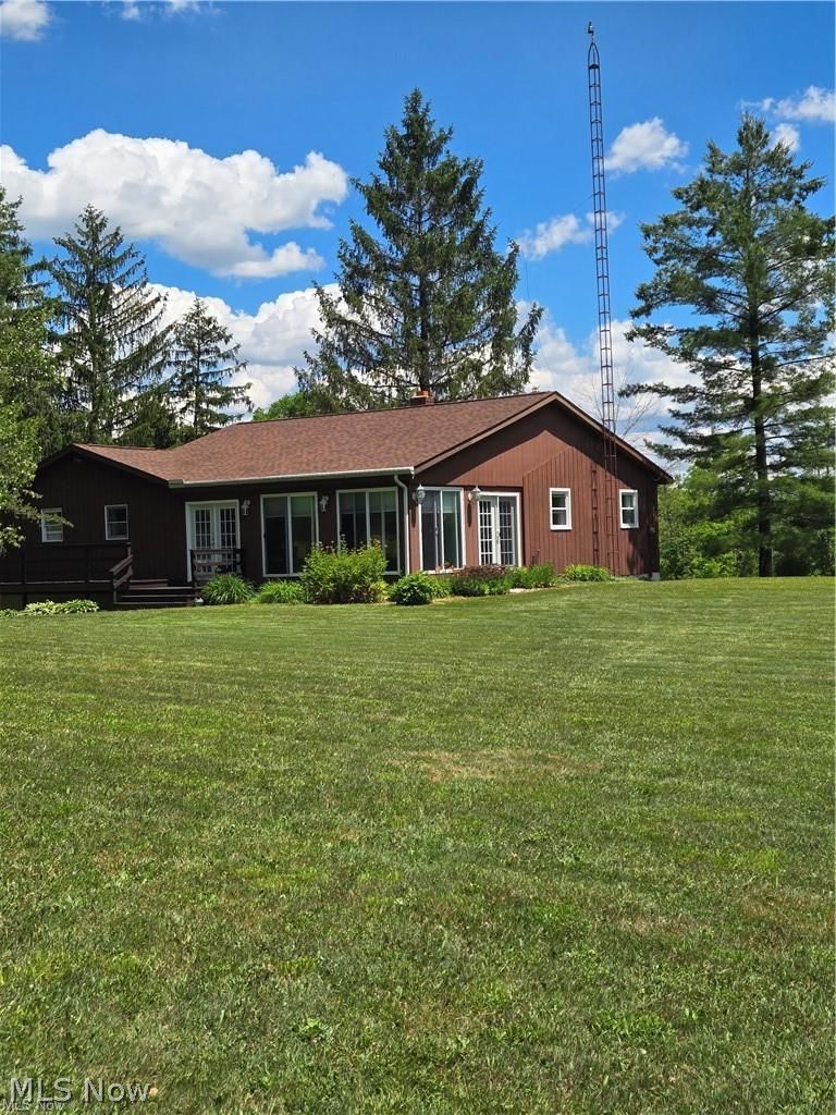 14640 Stone Road Newbury, OH 44065 - Photo 3 of 19 Nestled into the hillside, the back of the home has walls of glass