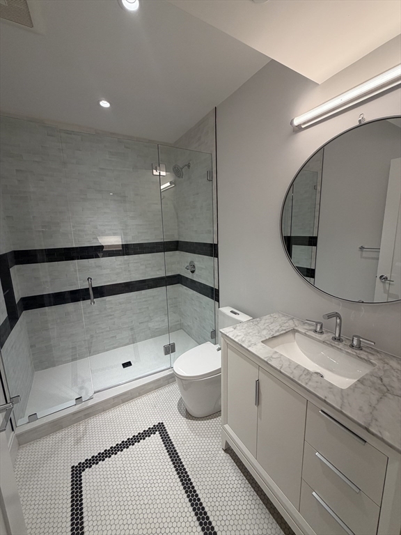 65 L Street, Unit 1 Boston, MA 02127 - Photo 8 of 9 a bathroom with a double vanity sink and mirror