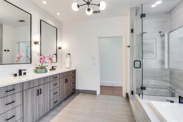 a bathroom with a double vanity sink mirror double and shower