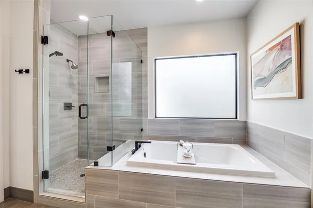 a bathroom with a bathtub and a shower