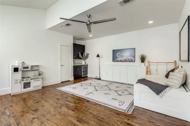 a living room with furniture stove and a refrigerator