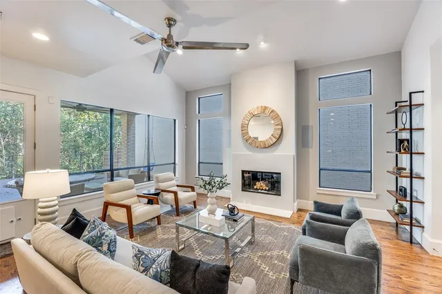 a living room with fireplace furniture and a large window