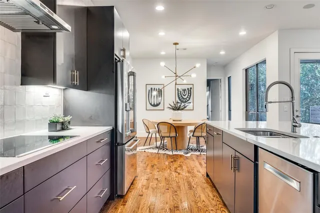 a kitchen with kitchen island granite countertop a sink and appliances
