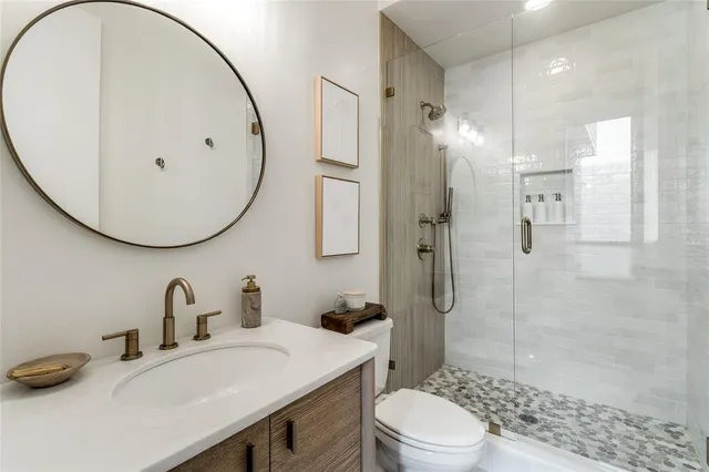 a bathroom with a sink toilet and shower
