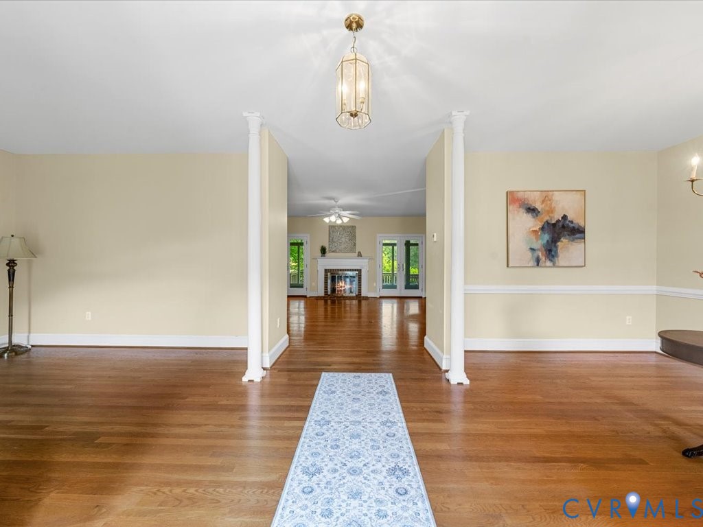 5515 Herring Creek Road Aylett, VA 23009 - Photo 14 of 50 a view of a hallway view with wooden floor and a chandelier