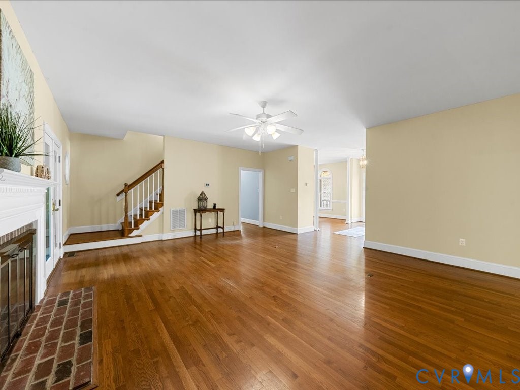 5515 Herring Creek Road Aylett, VA 23009 - Photo 20 of 50 a view of an empty room with wooden floor and a fireplace