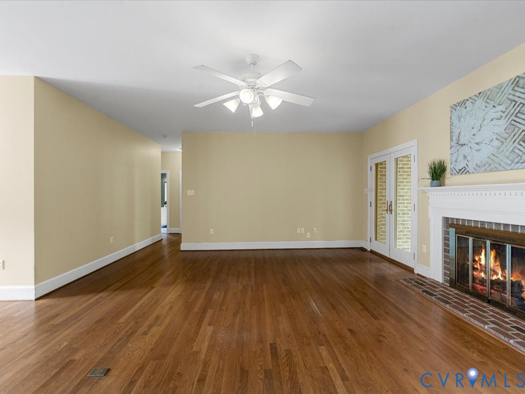5515 Herring Creek Road Aylett, VA 23009 - Photo 21 of 50 a view of an empty room with wooden floor fireplace and a window