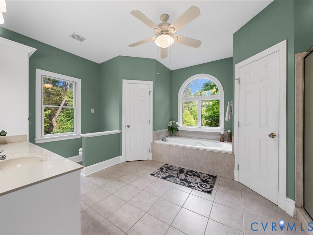 5515 Herring Creek Road Aylett, VA 23009 - Photo 31 of 50 a view of spacious bedroom with a window and a chandelier fan