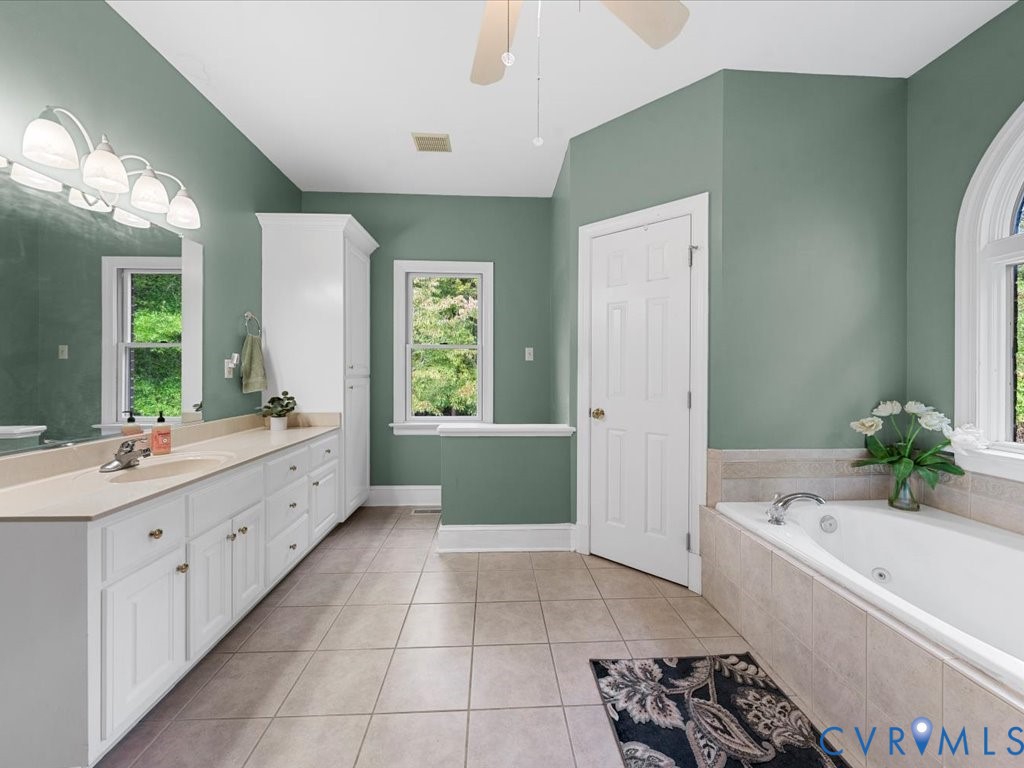 5515 Herring Creek Road Aylett, VA 23009 - Photo 32 of 50 a bathroom with a tub sink and mirror