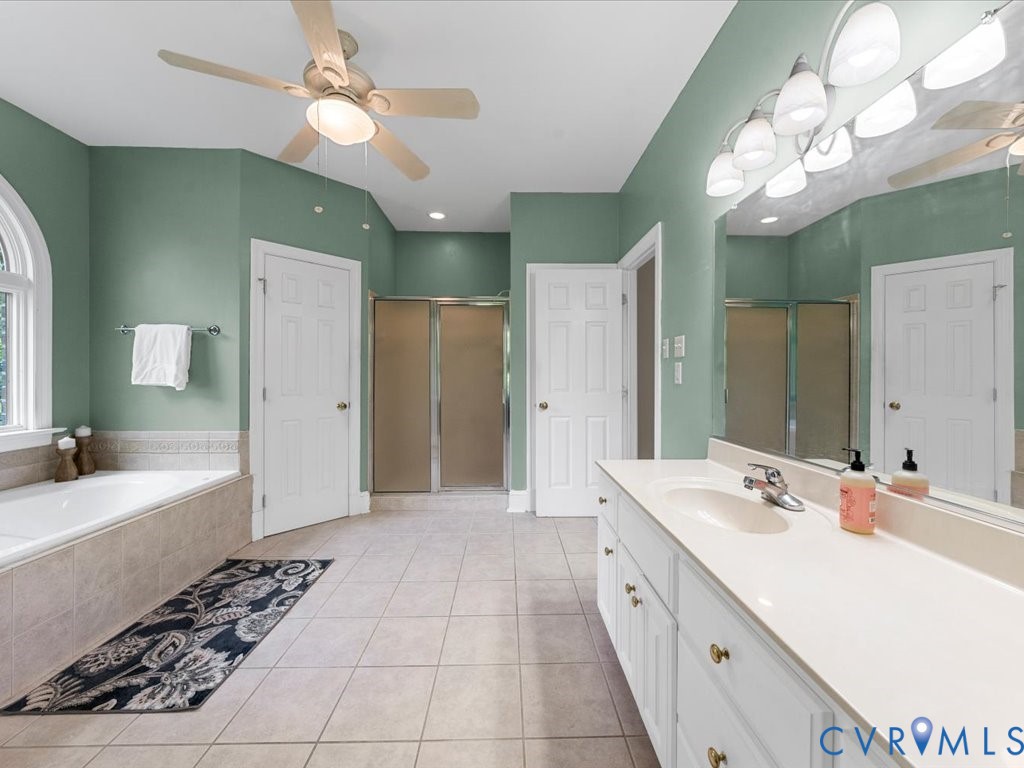 5515 Herring Creek Road Aylett, VA 23009 - Photo 33 of 50 a spacious bathroom with a double vanity sink a large mirror and a shower