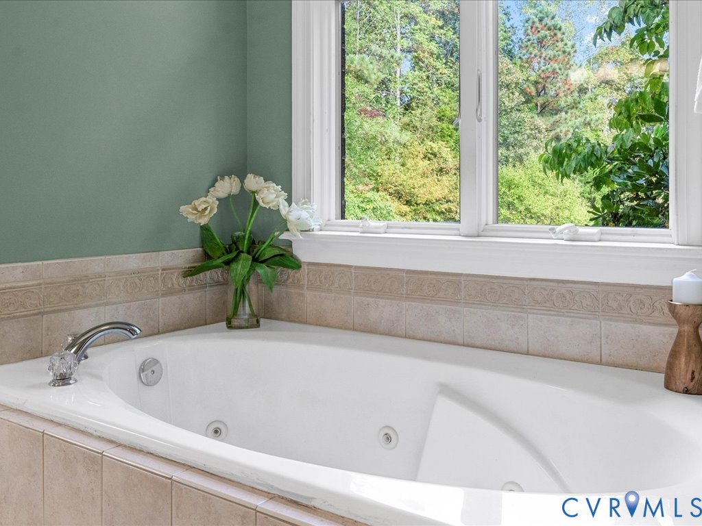 5515 Herring Creek Road Aylett, VA 23009 - Photo 35 of 50 a bath tub sitting in a bathroom next to a window