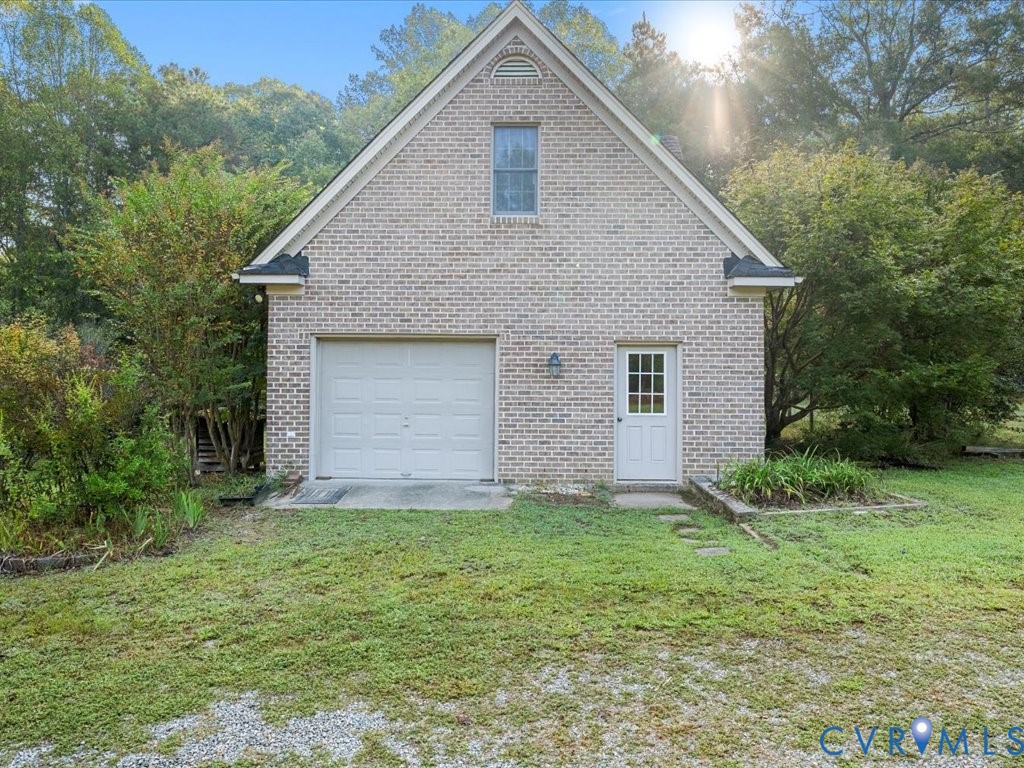 5515 Herring Creek Road Aylett, VA 23009 - Photo 48 of 50 a front view of a house with a yard and garage