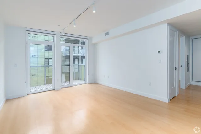 a view of an empty room with glass door