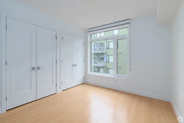 a view of an empty room with a window