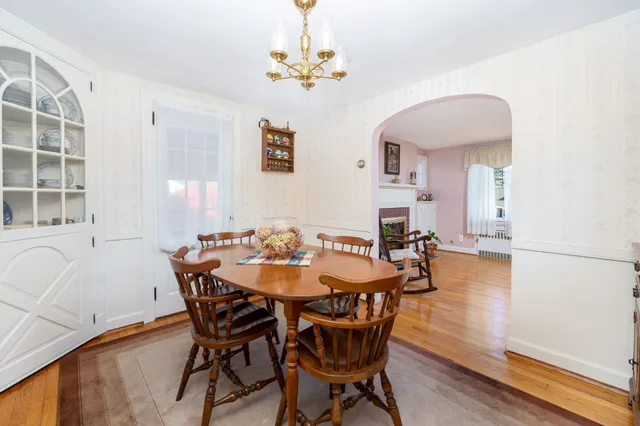 a dining room with a table chairs and a kitchen view