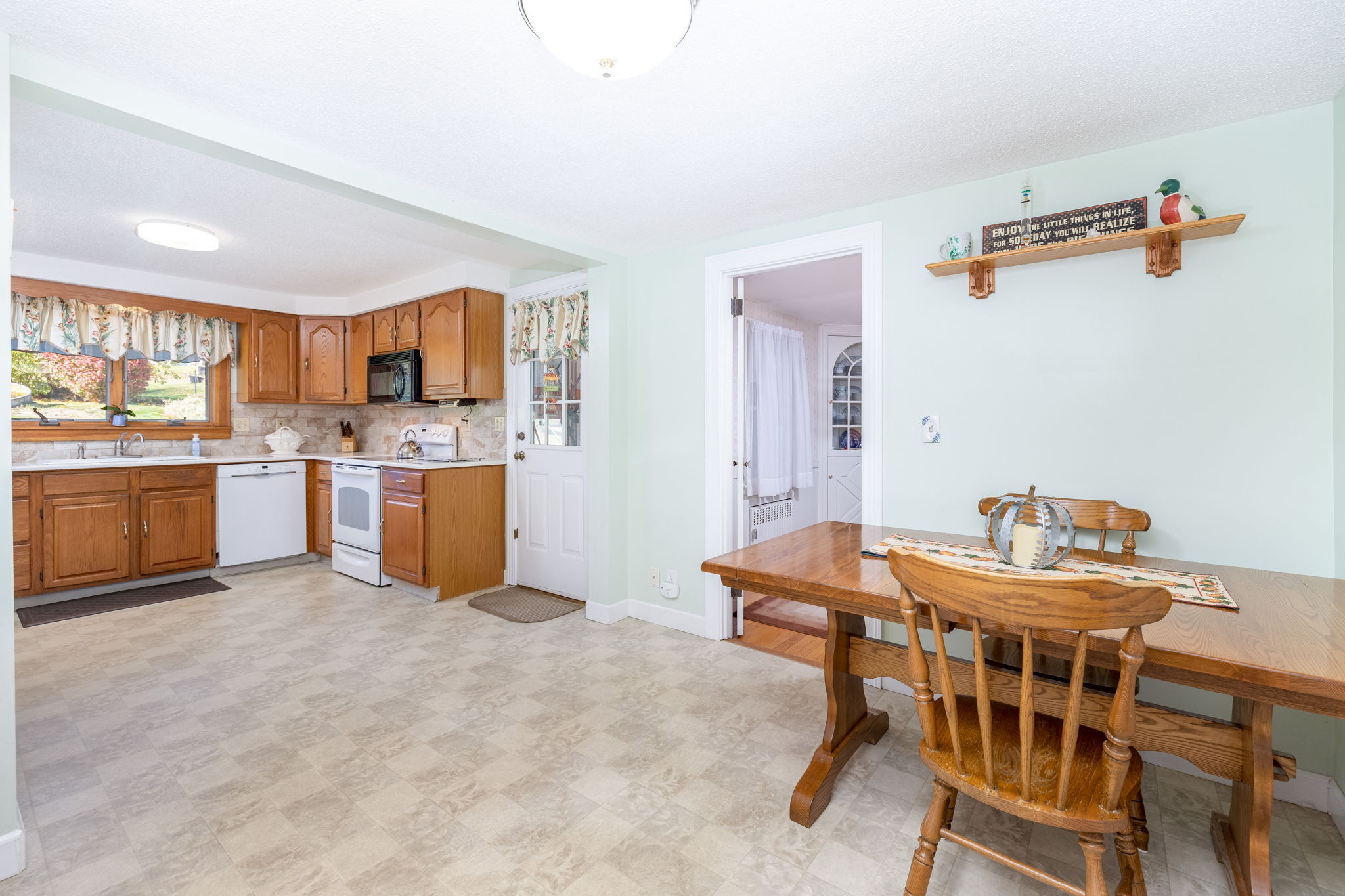 231 Charter Road Rocky Hill, CT 06067 - Photo 12 of 37 a dining room with a table chairs and a kitchen view