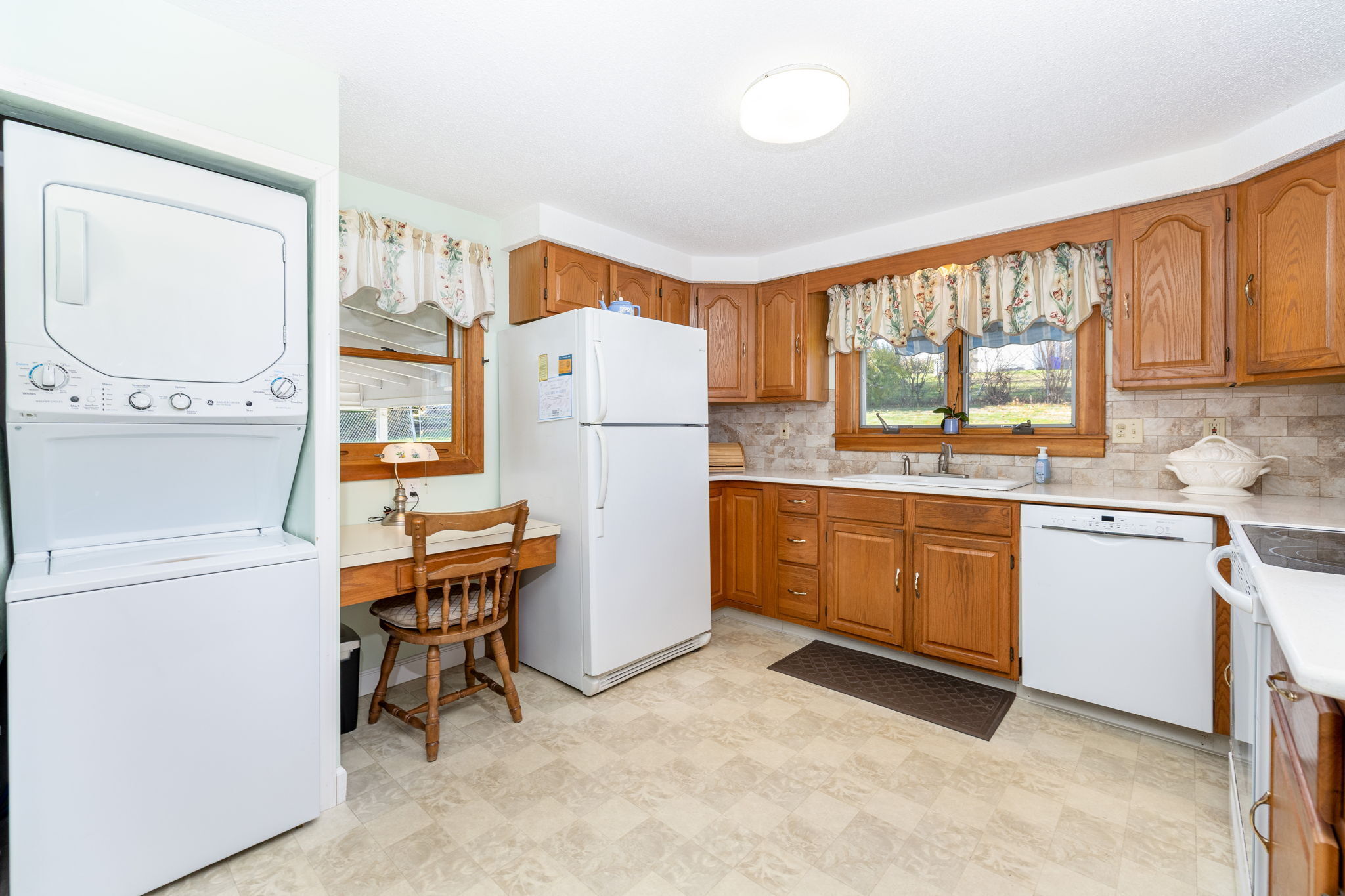 231 Charter Road Rocky Hill, CT 06067 - Photo 14 of 37 a kitchen with a refrigerator a stove a sink a dining table and chairs