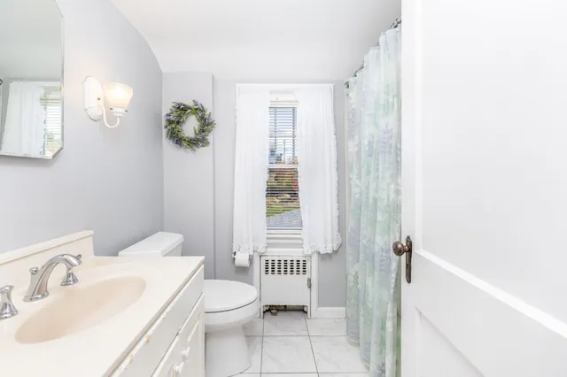 a view of a bedroom with furniture and window