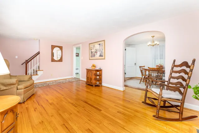 a view of a dining room with furniture and chandelier