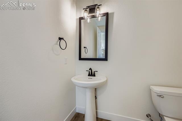 7989 Polson Drive Colorado Springs, CO 80908 - Photo 10 of 28 Bathroom with baseboards and wood finished floors