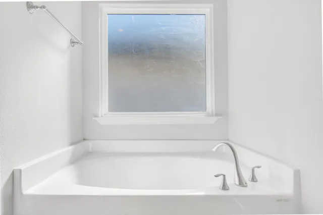 a white bath tub sitting next to a window