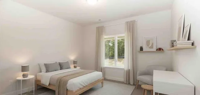 a bedroom with a bed and a chair